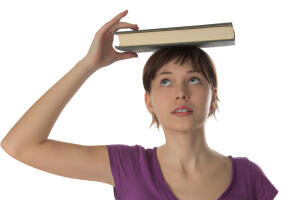 beautiful-girl-holds-book-on-a-head
